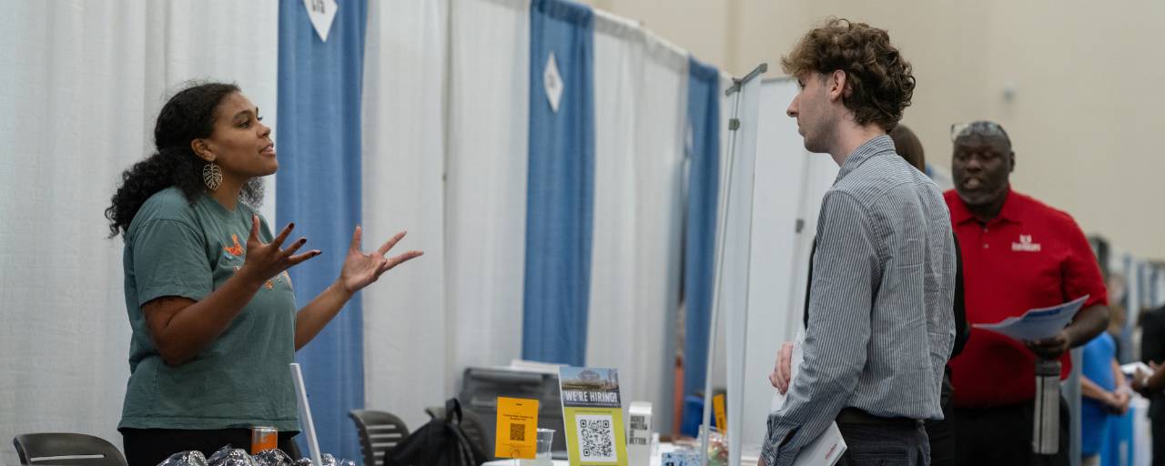 people talking at career fair